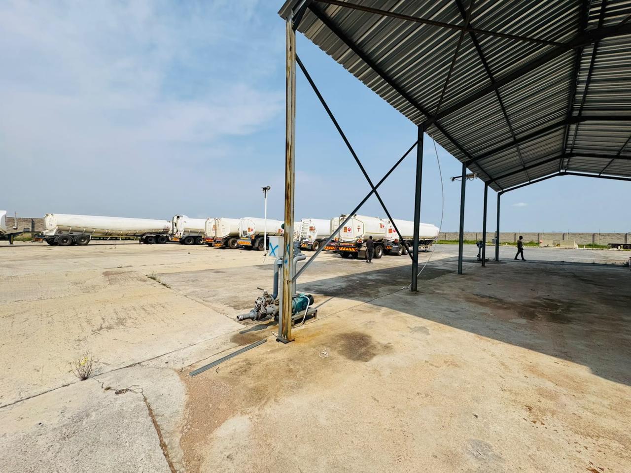 Fuel tanker trailers lined up at a covered loading bay